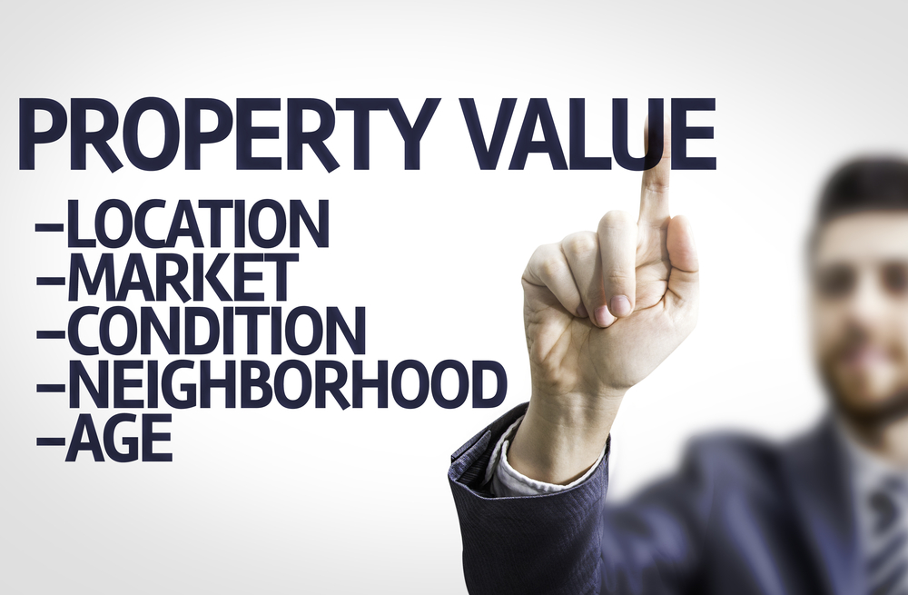 Business-man-pointing-to-transparent-board-with-text-Property-Value