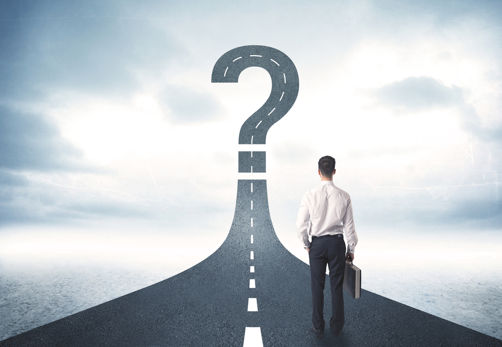 Business-person-looking-at-road-with-question-mark-sign-concept