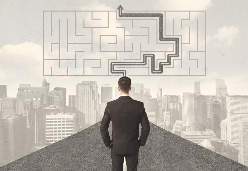 Businessman-looking-at-road-with-maze-and-solution-concept