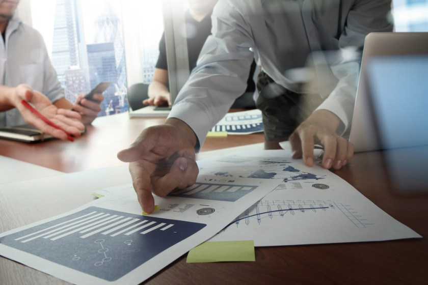 Double-exposure-of-businessman-hand-working-with-new-modern-computer-and-business-strategy-as-concept