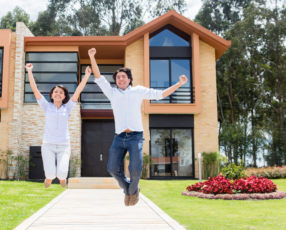 Excited-couple-jumping-after-buying-a-house