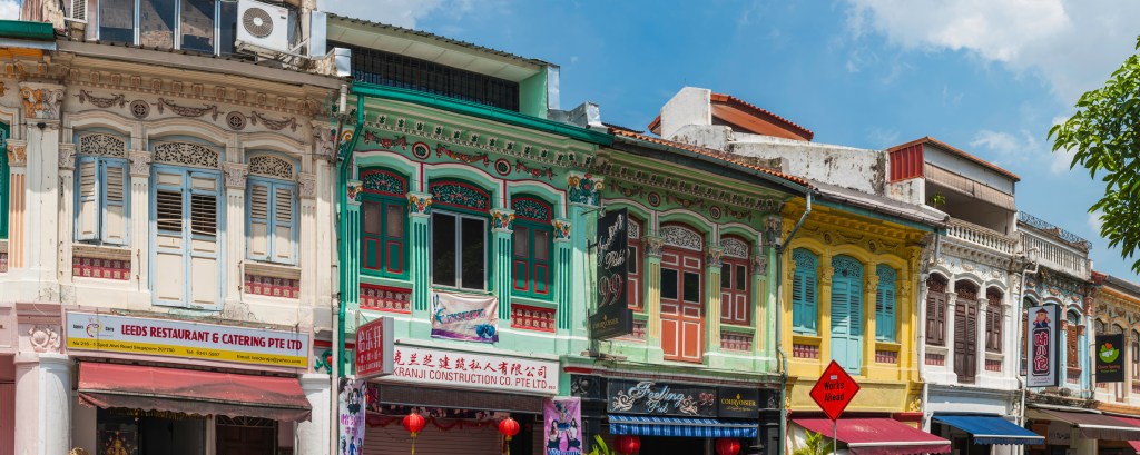 Colourful buildings shop and shutters panorama Little India Singapore