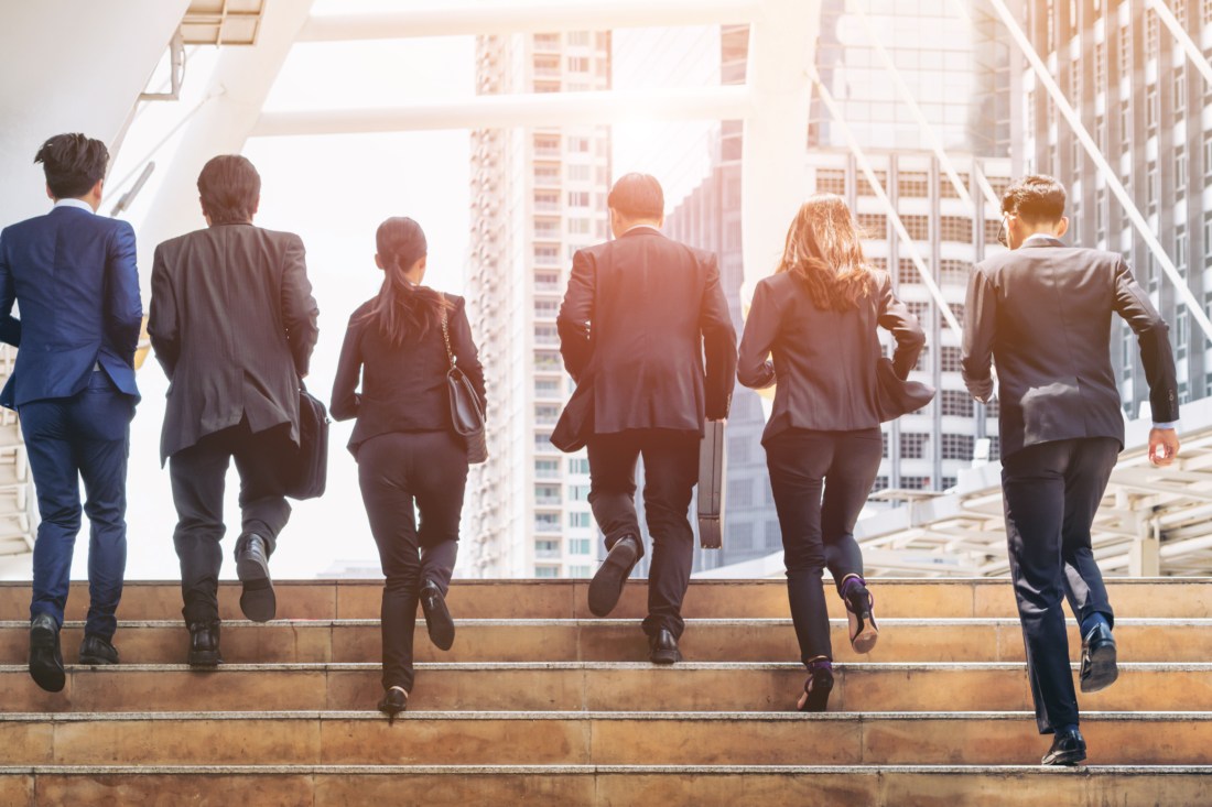 Group of Business People Running in Row