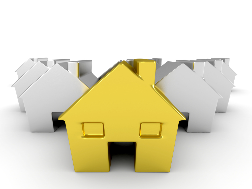 Golden-house-among-silver-ones-isolate-dover-a-white-backround