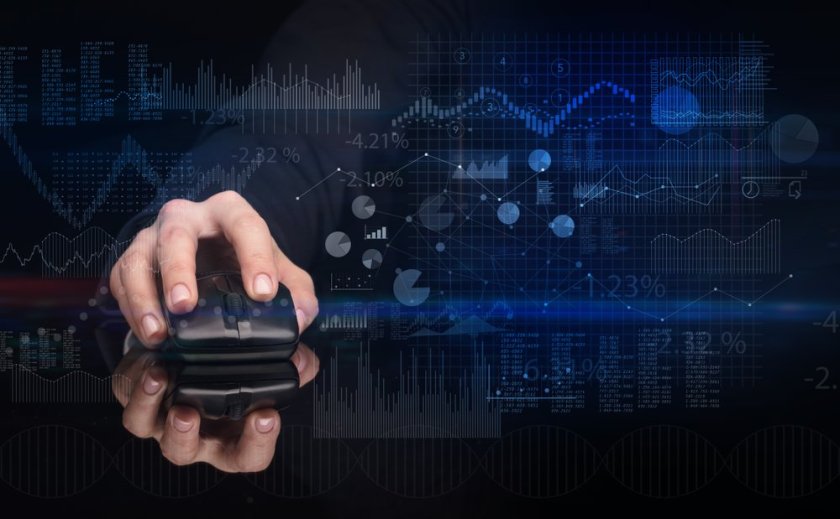 Hand-using-wireless-mouse-with-financial-concept-on-dark-background