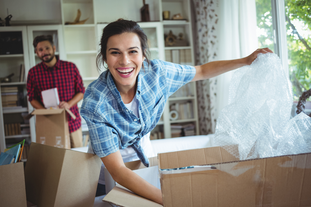 Happy-couple-unpacking-cartons-in-their-new-house-1