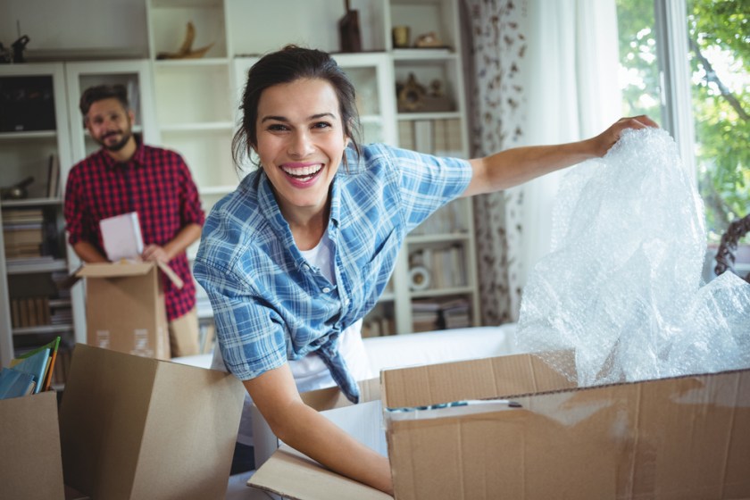 Happy-couple-unpacking-cartons-in-their-new-house