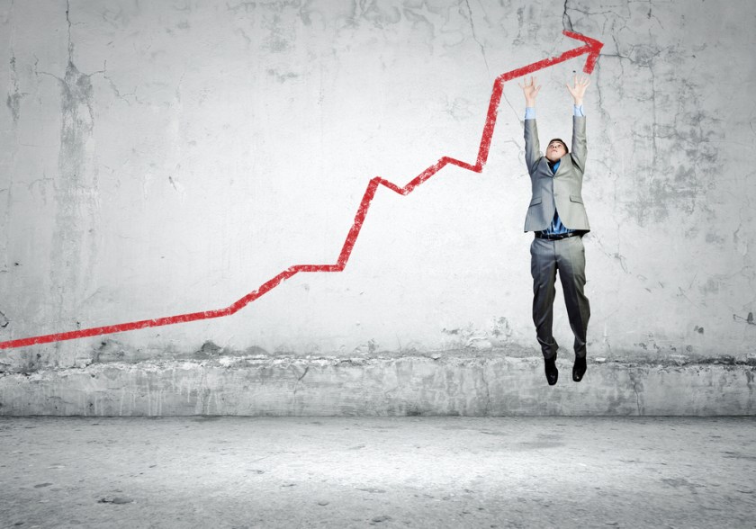 Image-of-young-businessman-jumping-above-graph