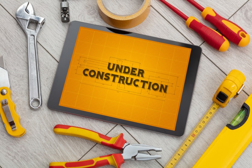Tablet-and-tools-with-home-under-construction-concept