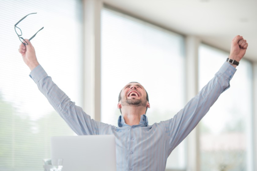 Victorious-corporate-man-celebrating-with-his-arms-lifted-in-the-air