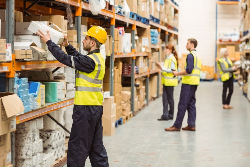 Warehouse-worker-taking-package-in-the-shelf-in-a-large-warehouse-in-a-large-warehouse