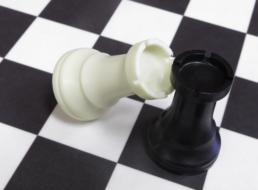White-rook-topples-against-black-rook-on-chessboard