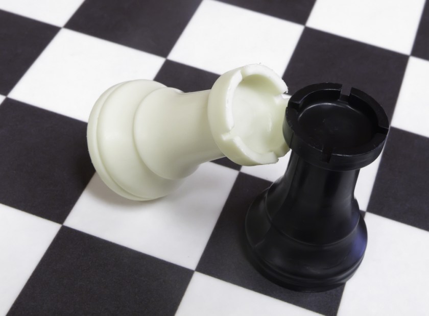 White-rook-topples-against-black-rook-on-chessboard