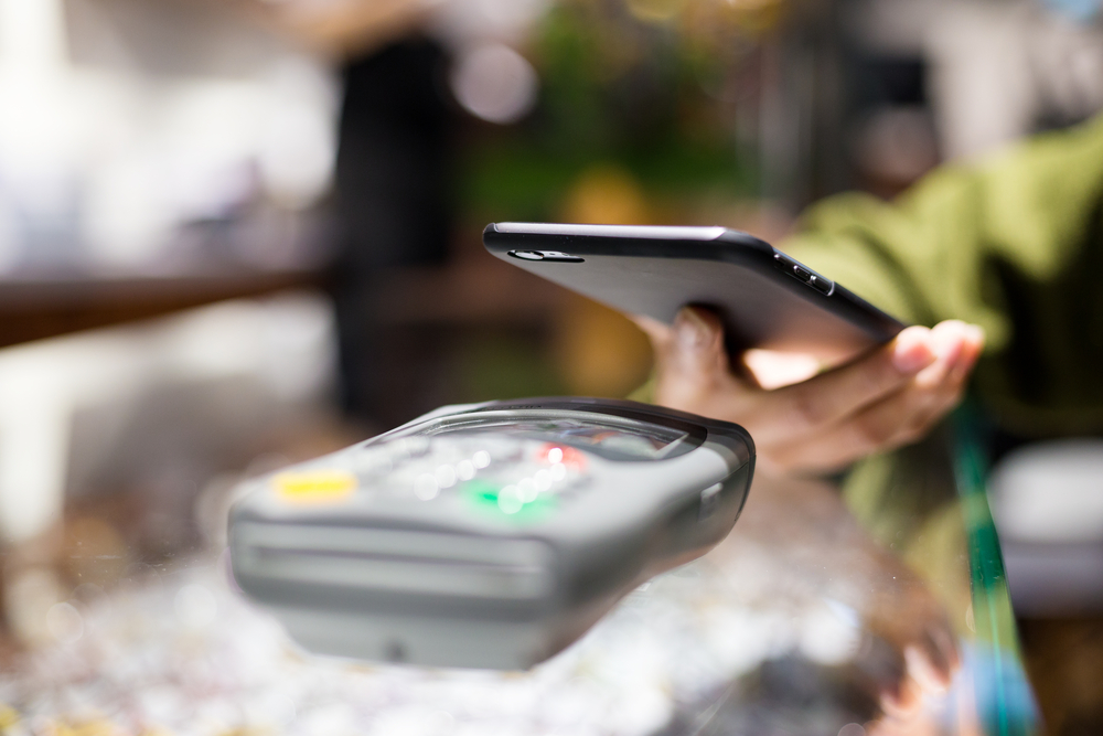 Woman-paying-with-smartphone-by-NFC
