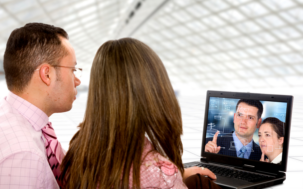 business-couple-on-a-laptop-in-an-office-environment-watching-a-trainning-video