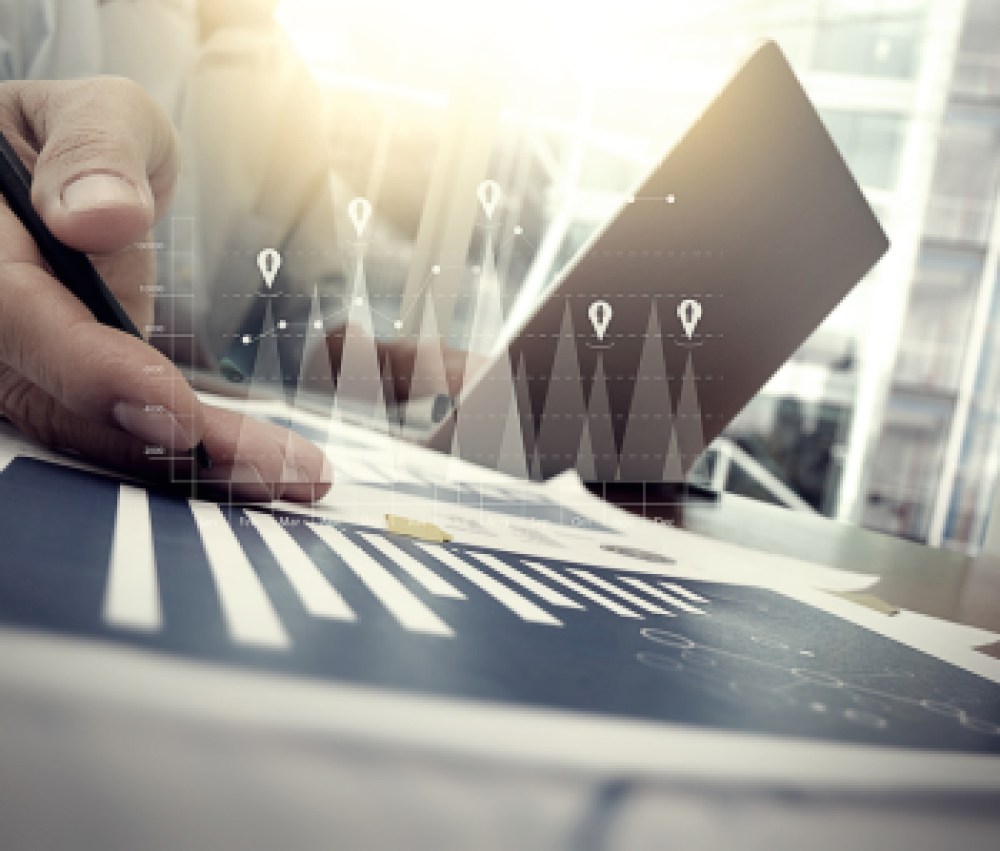 business-documents-on-office-table-with-smart-phone-and-digital-tablet-and-graph-financial-with-social-network-diagram-and-man-working-in-the-background