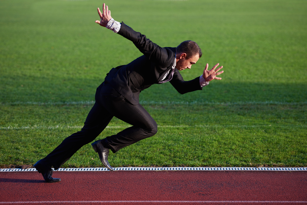 business-man-in-start-position-ready-to-run-and-sprint-on-athletics-racing-track