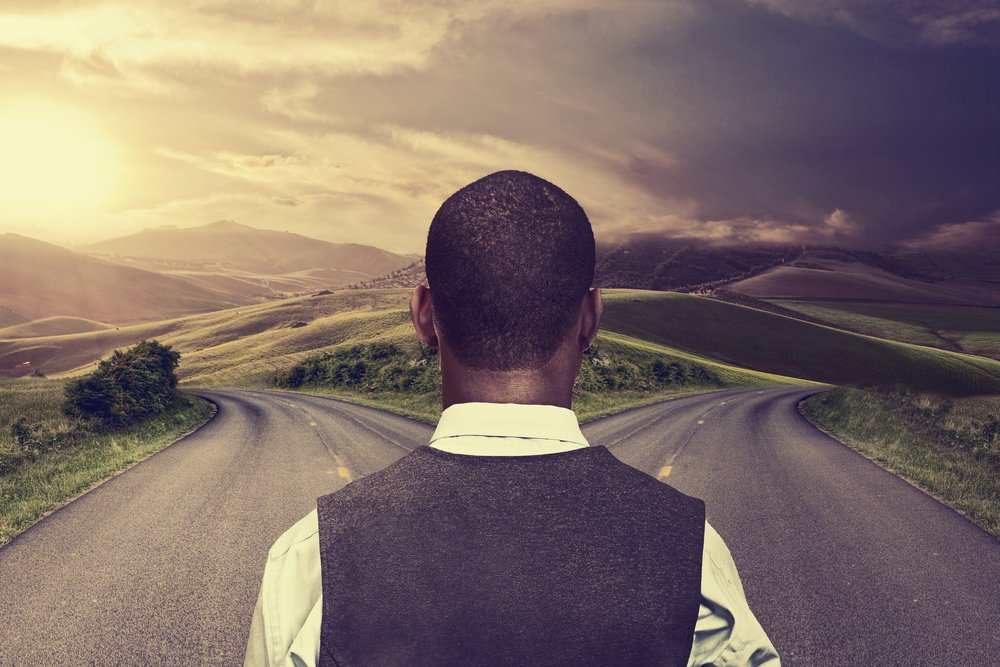 businessman-in-front-of-two-roads-hoping-for-best-taking-chance