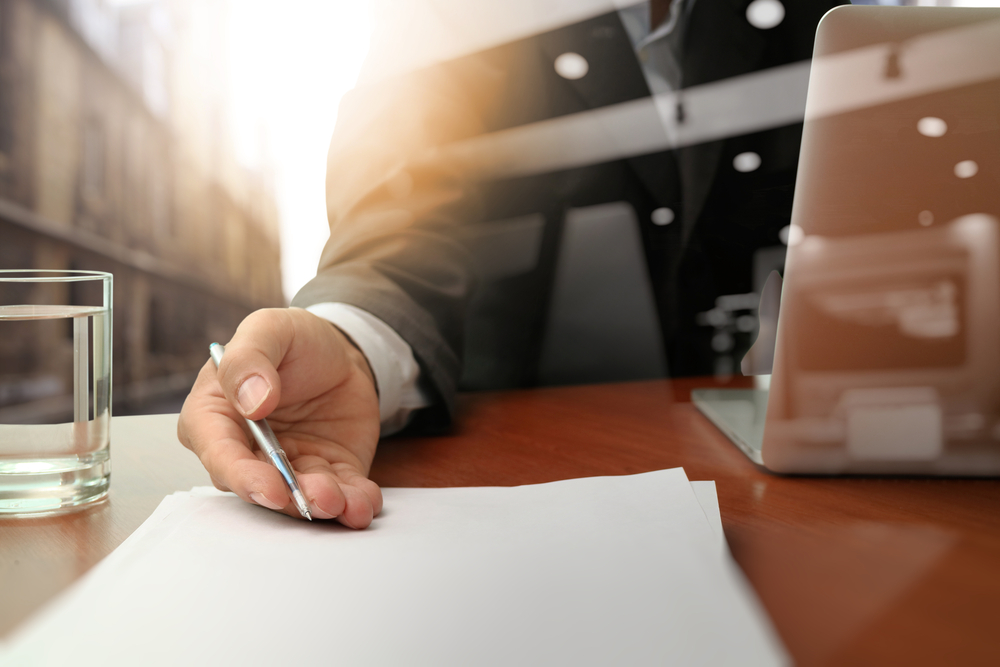 double-exposure-of-businessman-or-salesman-handing-over-a-contract-on-wooden-desk-1