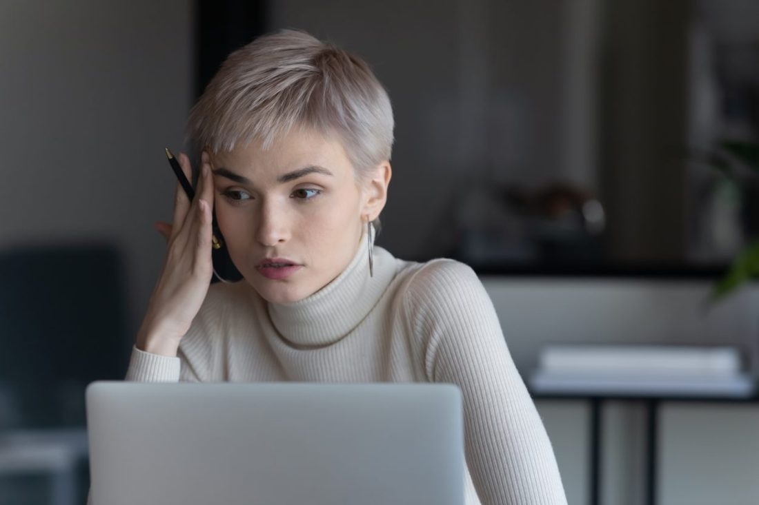 Businesswoman sitting at workplace search solution having problem feels confused