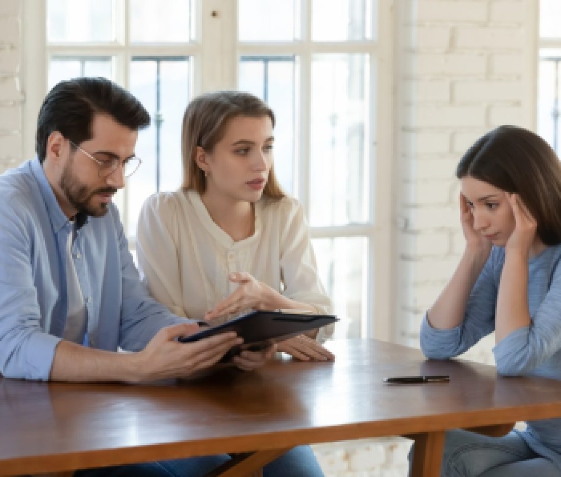 Female realtor stressed by difficult couple clients