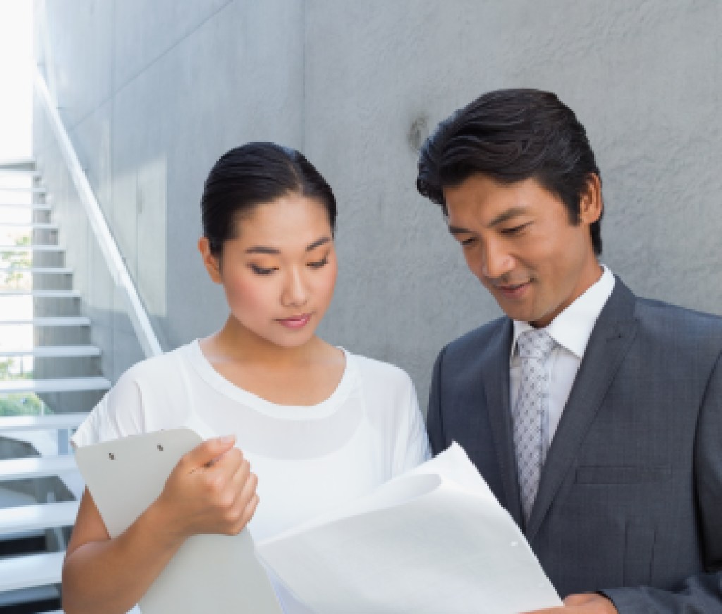 Estate agent showing lease to customer and smiling