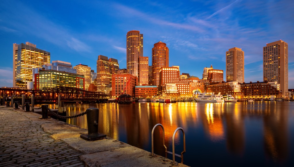 Boston harbor with cityscape and skyline on sunset