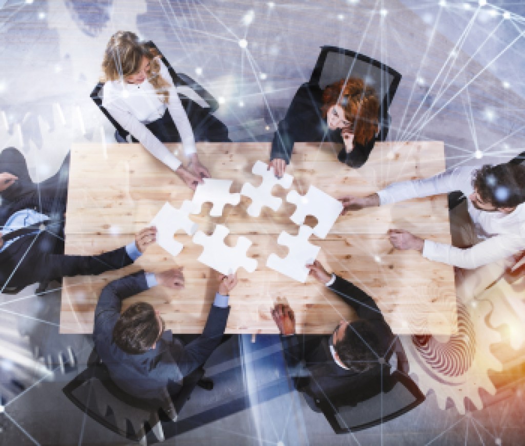 Teamwork of partners. Concept of integration and startup with puzzle pieces and gear overlay. double exposure with network effects