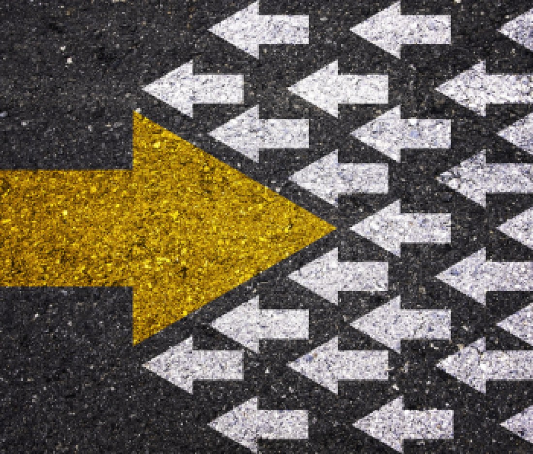 Different thinking and Business and technology disruption concept. Yellow big arrow opposite  direction with white arrow on road asphalt.