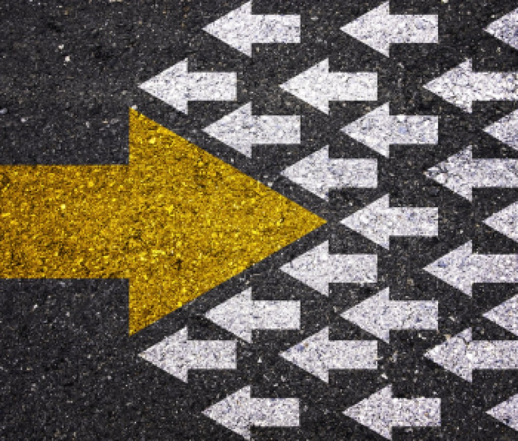 Different thinking and Business and technology disruption concept. Yellow big arrow opposite  direction with white arrow on road asphalt.