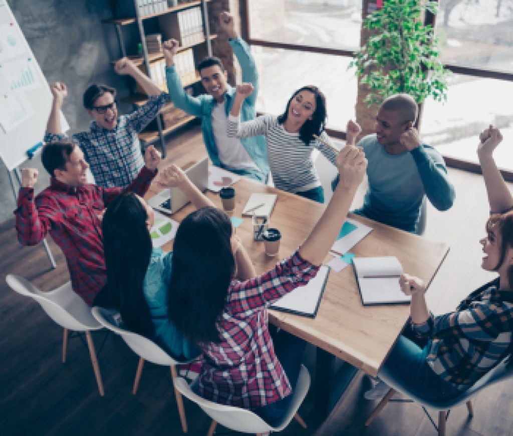 Above high angle view of nice attractive beautiful handsome cheerful executive managers wearing casual sitting rejoice at industrial loft interior workplace workstation open space indoors