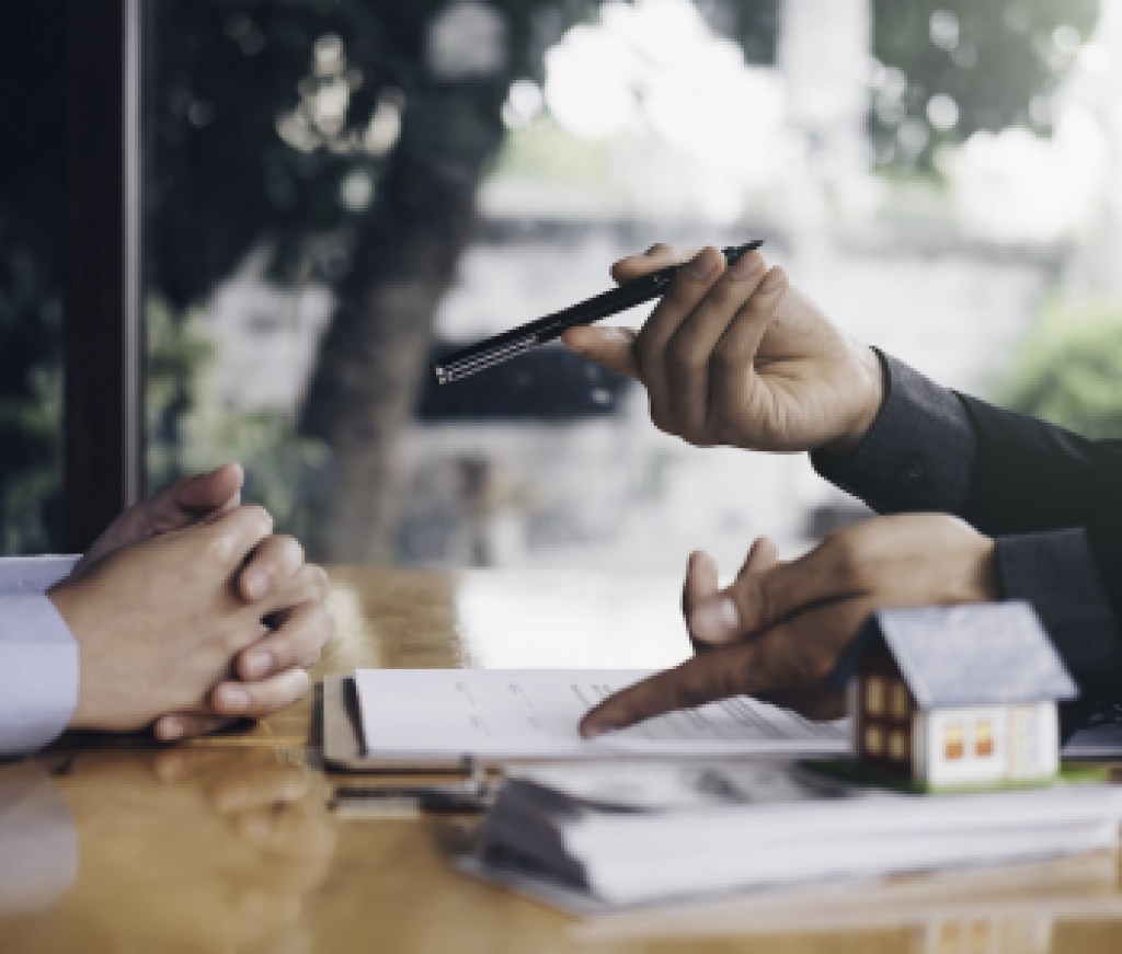 real estate agent holding house key to his client after signing contract,concept for real estate, moving home or renting property