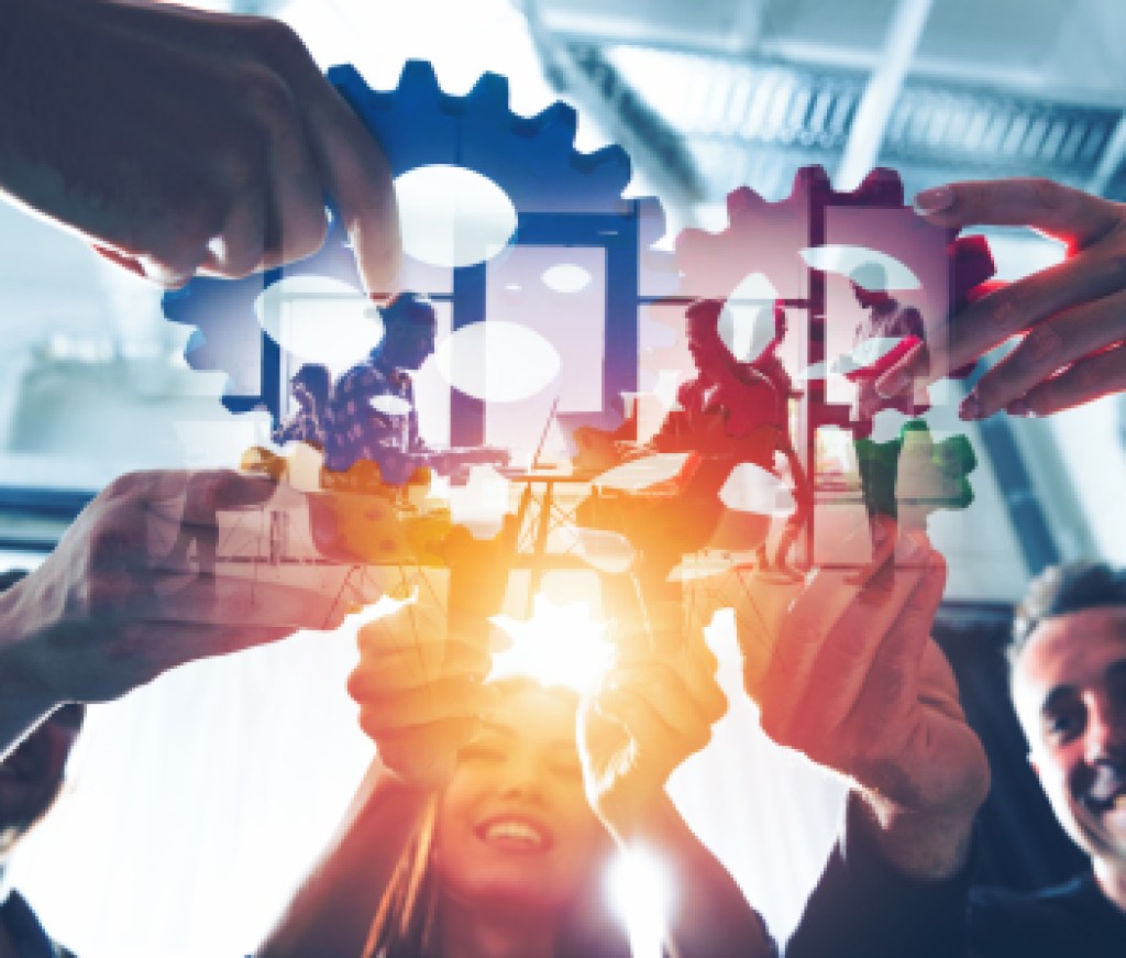 Business team connect pieces of gears. Teamwork, partnership and integration concept. double exposure with light effects