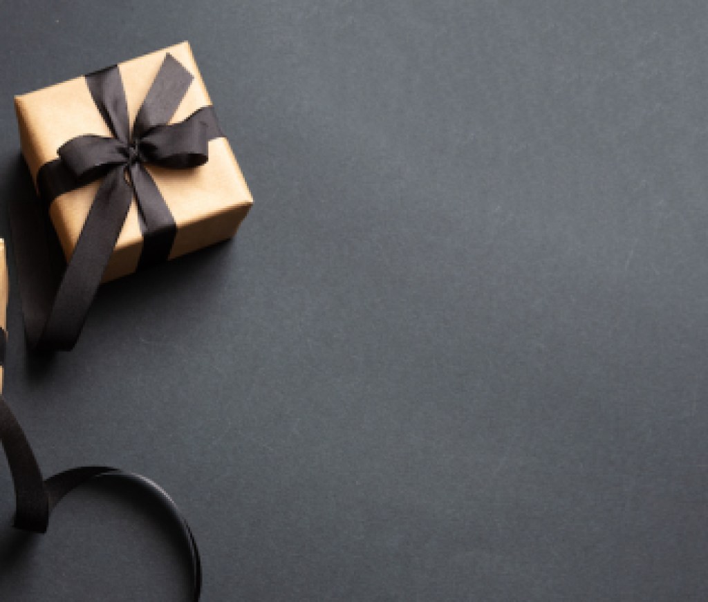Gifts with black ribbon against black background, Black Friday concept.