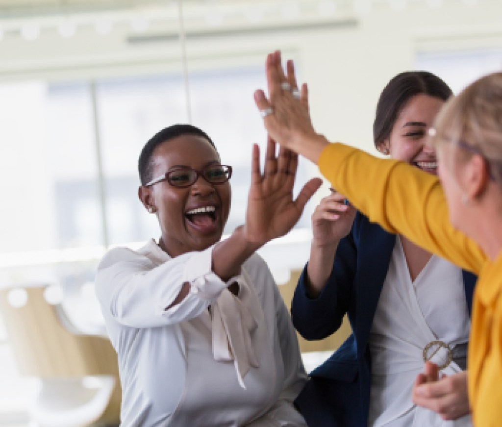 agent teams high-fiving in office
