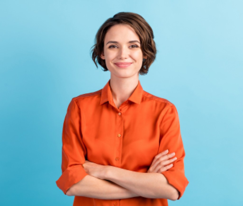 Photo of attractive charming lady cute bobbed hairdo arms crossed self-confident person worker friendly smile good mood wear orange office shirt isolated blue color background