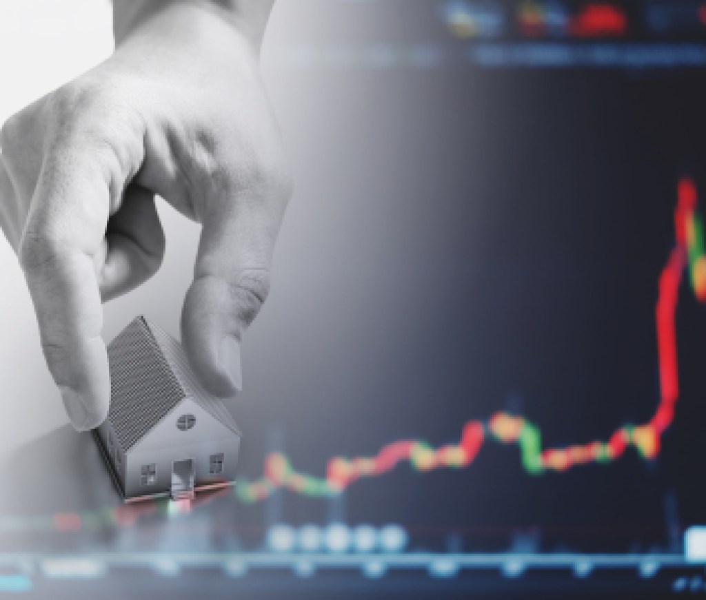 Hand holding house, with raising graph background. Real estate business and investment in real estate concept