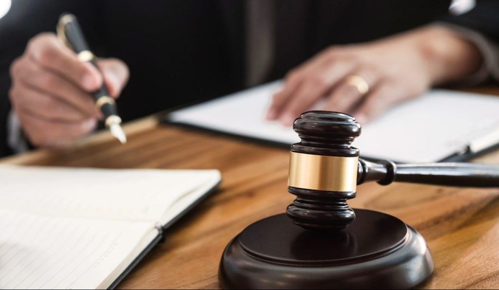 justice lawyer / judge gavel working with legal documents in a court room